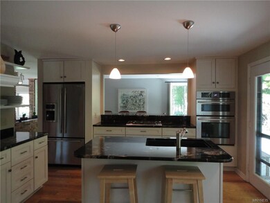 Kitchen is open to dining room, and glass door lea