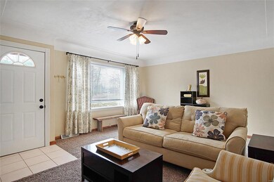 Light filled living room with a cove ceiling.