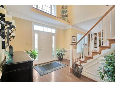Bright 2 story foyer with picture frame wainscotti