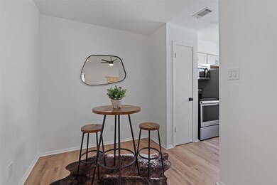 Dining area with light wood-style floors and base