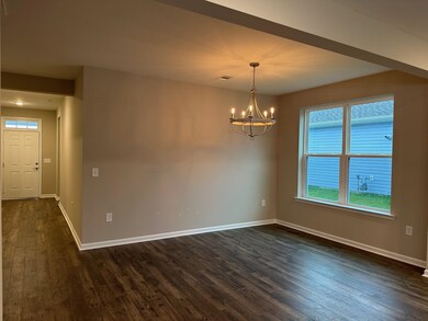 Unfurnished room featuring an inviting chandelier 