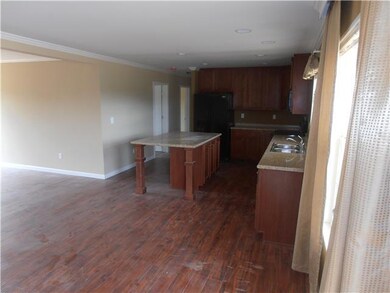 Spacious open floor plan with upgraded black appliances, including the fridge, laminate flooring and crown molding throughout!