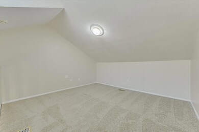 Additional living space featuring lofted ceiling,