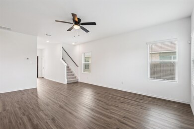 Unfurnished room featuring stairs, dark wood-type