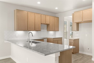 This kitchen is by far any chef’s dream! This spacious kitchen features high ceilings, light stained wood cabinets, granite countertops, SS appliances, modern tile backsplash, recessed lighting, extended counter space, granite kitchen island with space for breakfast bar, and a walk-in pantry all overlooking your huge family room.
