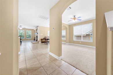 Hallway with arched walkways, light tile patterne