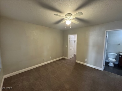 Unfurnished bedroom featuring dark colored carpet,