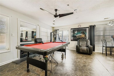 Recreation room with pool table, a textured ceiling, and a ceiling fan