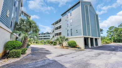 View of property featuring driveway