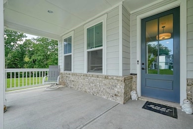Doorway to property with covered porch