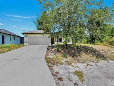 Ranch-style house with concrete driveway, stucco s