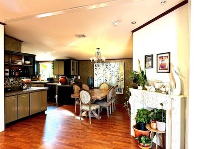 Dining space with an inviting chandelier, dark woo