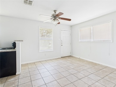 Unfurnished living room with ceiling fan, light ti