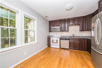 Kitchen with granite counter tops and under cabine