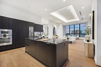 The kitchen showcases sleek, modern design and exceptional functionality. Offering high-end finishes and clean lines, it is a sophisticated space where style meets practicality, ideal for both everyday living and entertaining.