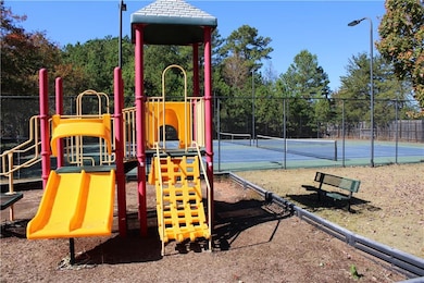 Communal playground featuring a tennis court