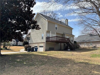 Rear view of house featuring an attached garage, s