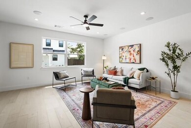 Living room featuring light wood-type flooring, recessed lighting, and ceiling fan