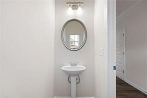 Bathroom with baseboards and wood finished floors