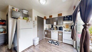 Kitchen with light wood finished floors, light cou