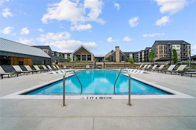 Community pool featuring a patio, fence, and a res