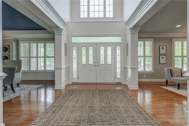 Step into a grand two-story foyer flanked by forma