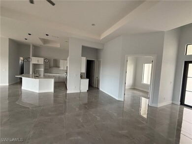 Kitchen featuring white cabinets, a high ceiling,