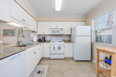 Kitchen with tasteful backsplash, crown molding, w