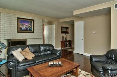 The Living Room is Warmed by Brick Fireplace * Bi-