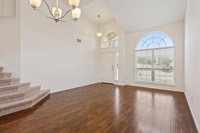 Foyer featuring a chandelier, dark wood-style flo