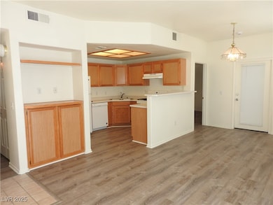 Kitchen featuring dishwasher, a sink, under cabine