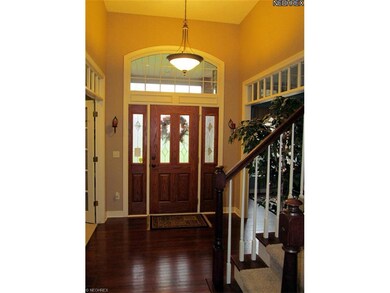 The foyer features hardwood floors, 12' ceilings a