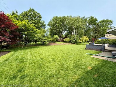 View of green lawn featuring a patio