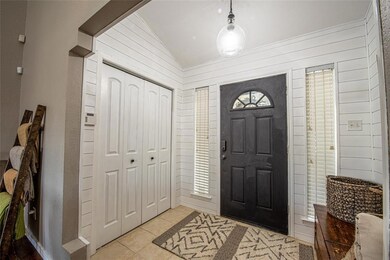 Quaint entry with storage closet and shiplap