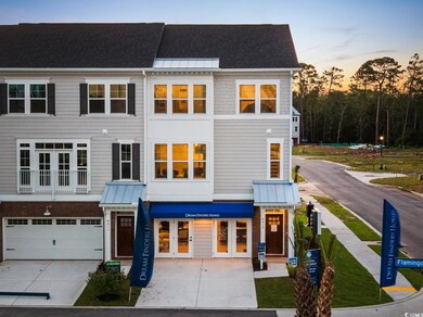 Multi unit property featuring driveway, an attached garage, a standing seam roof, and french doors
