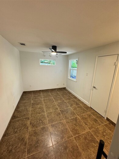 Empty room featuring dark tile patterned floors a