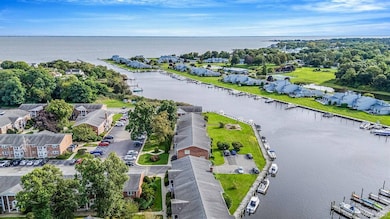 Aerial view of residential area featuring a nearby body of water