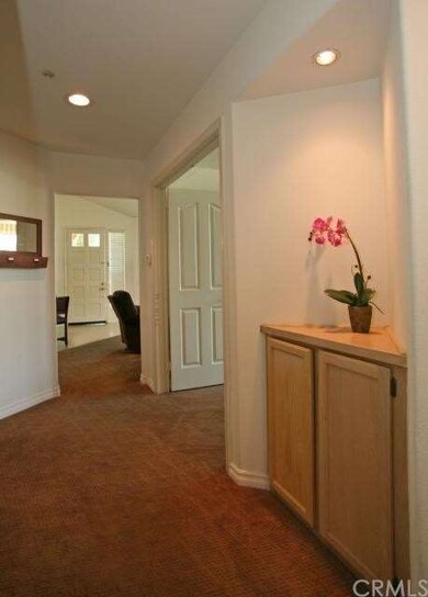 Pretty and open hallway features linen storage.