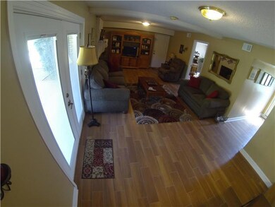 Door next to entertainment center leads to private laundry room and garage with lots of extra space for storage!