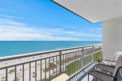 Balcony featuring a water view and a beach view