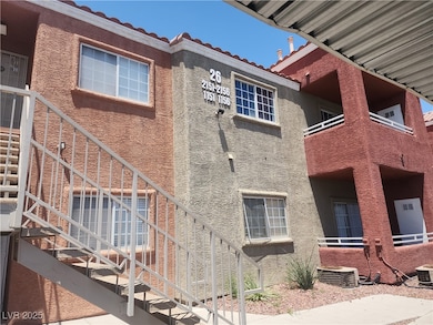 View of side of home featuring a tile roof, stucco
