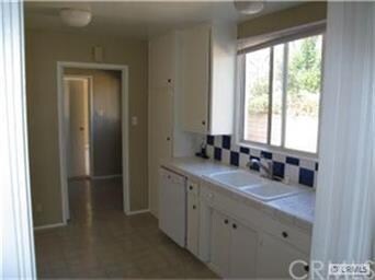 Kitchen With Custom, Checkered Tile Back Splash.