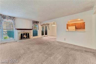 Unfurnished living room with a textured ceiling, c