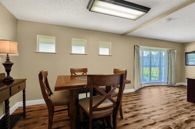 Dining area featuring wood-type flooring and a textured ceiling