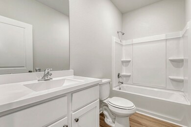 The secondary bathroom is conveniently located cen