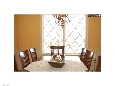 Formal dining room has custom paneling and oak flo