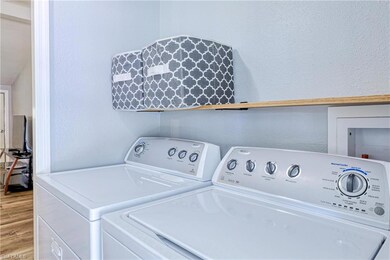 Living area featuring new luxury vinyl tile floors and baseboards, with lofted ceiling