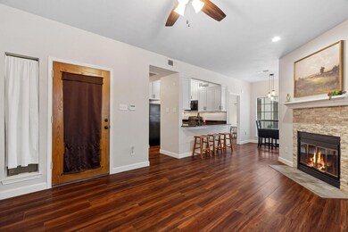 Living area with a ceiling fan, dark wood-style f