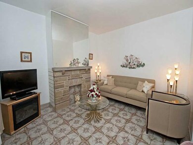Living Room. Decorative stone fireplace and Italia