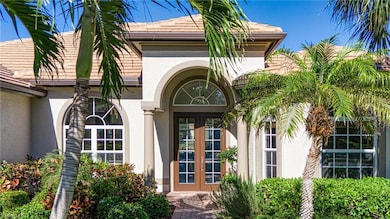 Property entrance featuring stucco siding, a tiled